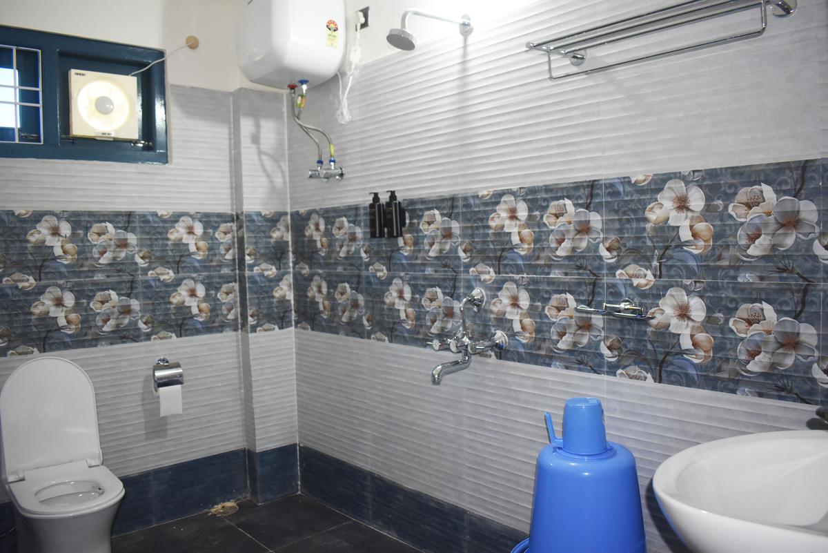 Bathroom with shower and washbasin at Hotel Pema Lhatse Dirang