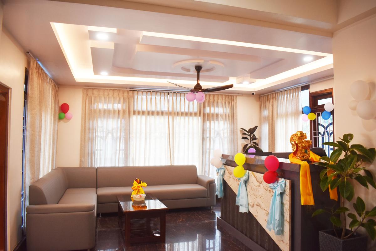 Hotel Pema Lhatse lobby waiting area with sofa, false ceiling and warm lighting